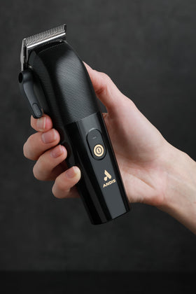 Andis Envy II cordless clipper in use in a school kit setup.
