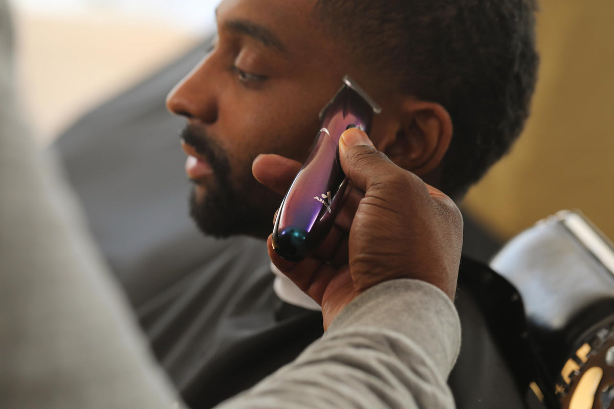 Andis Galaxy Envy trimmer in hand for comfortable control