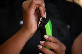 Andis ProClip digital display shows battery, speed, and travel lock at a glance.