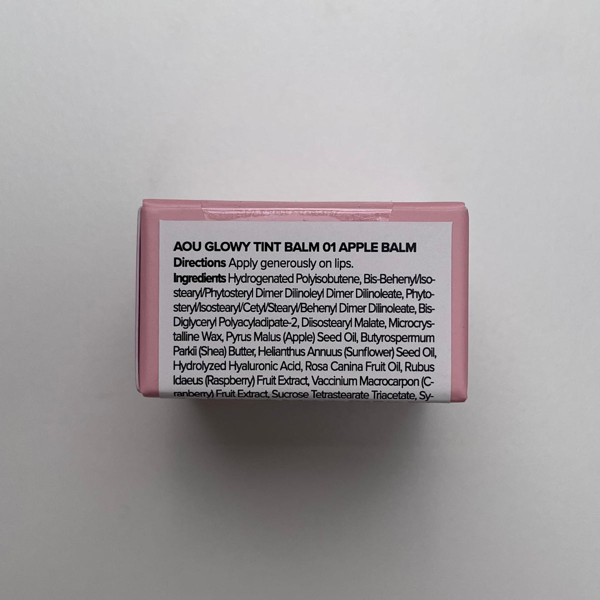 AOU Glowy Tint Balm on lips with a glossy pink finish