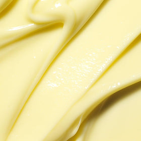 Close-up of APRILSKIN Carrotene Clarifying Cream texture on skin surface.