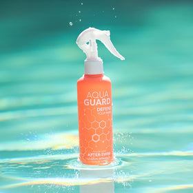 AQUA GUARD after-swim travel-size bottle on a bathroom shelf