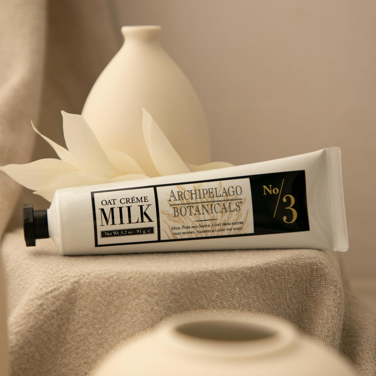 Applying Archipelago Botanicals Oat Milk Hand Crème to hands for comfort