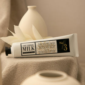 Applying Archipelago Botanicals Oat Milk Hand Crème to hands for comfort