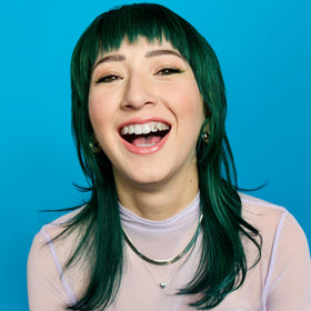 Hair after washing shows hydrated, vivid Emerald Fortune teal shade.
