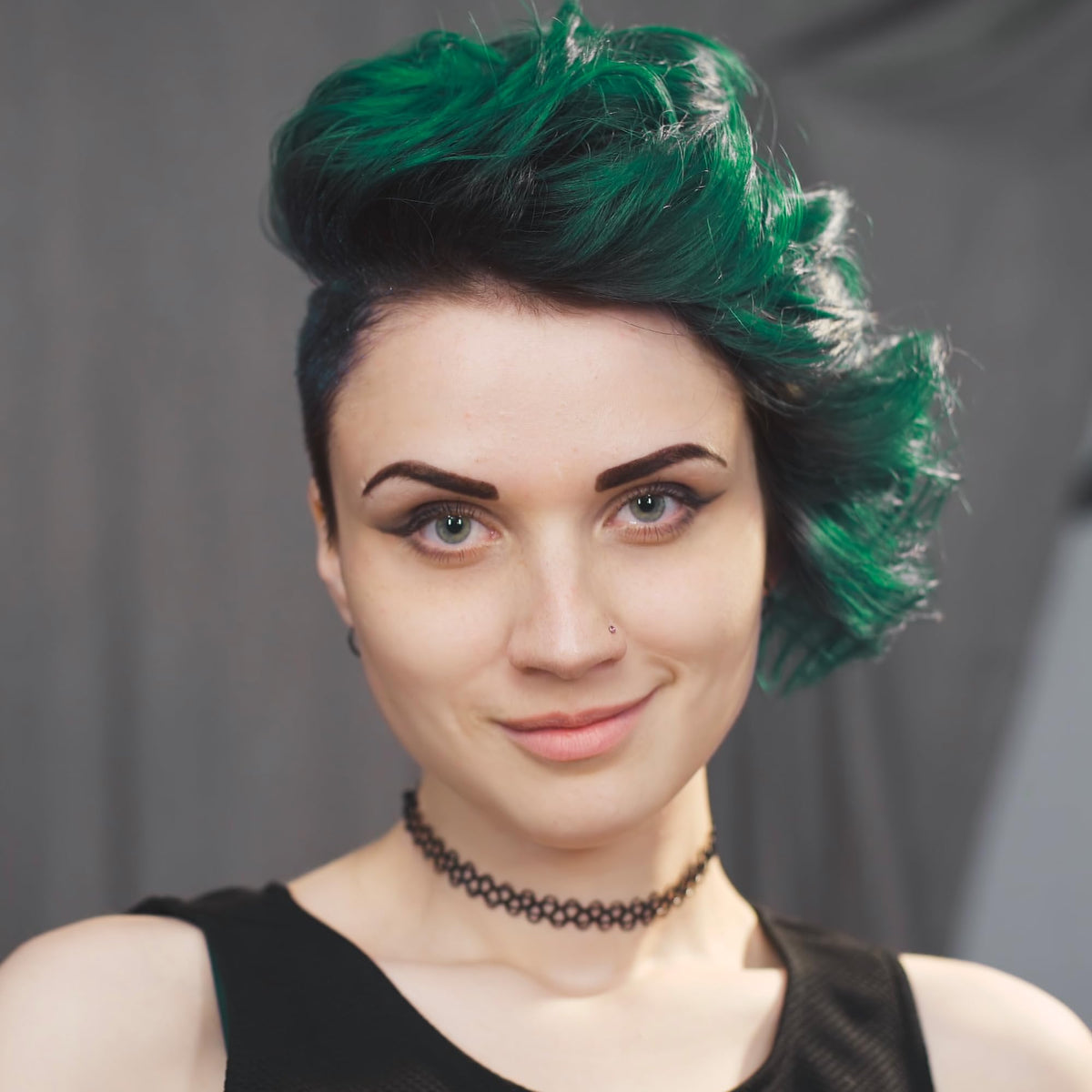 Swatches of Emerald Fortune teal showing bluish‑green multi‑dimensional shade