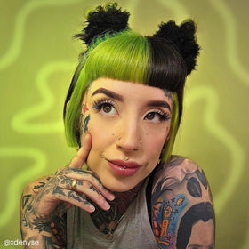 Arctic Fox Space Cowgirl green dye hair during application demonstrates bold color option.