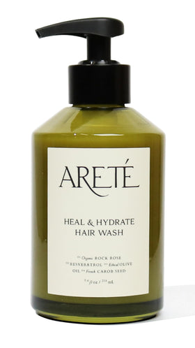 ARETÉ Heal & Hydrate shampoo bottle showcases organic ingredients for daily nourishment.