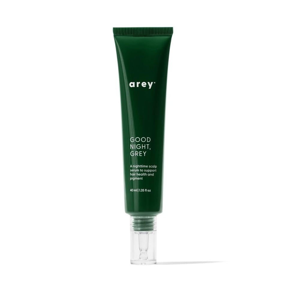 Arey Good Night Grey overnight scalp serum bottle on dresser supports color-safe nighttime care.
