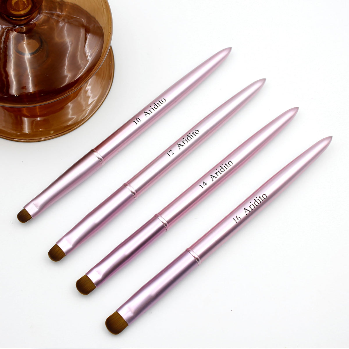 Aridito pink metal French-tip brush designed for accurate nail tip cleaning.