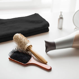 Absorbent Arkwright towels shown during hair styling to blot moisture efficiently.