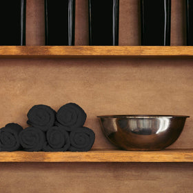 Folded Arkwright towels on a counter ready for spa or barber service.
