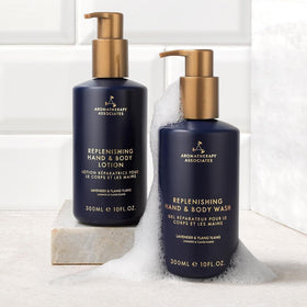 Aromatherapy Associates Balance Shampoo bottle with droplets of hydration on strands.