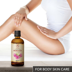 AROMATIKA Burdock Root Oil on hair, illustrating scalp nourishment and shine.