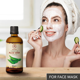 AROMATIKA Burdock Root Oil beside skincare products, highlighting versatile use.
