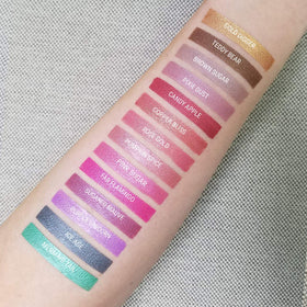 Aromi Fab Flamingo metallic swatch on skin demonstrates vibrant magenta shimmer.