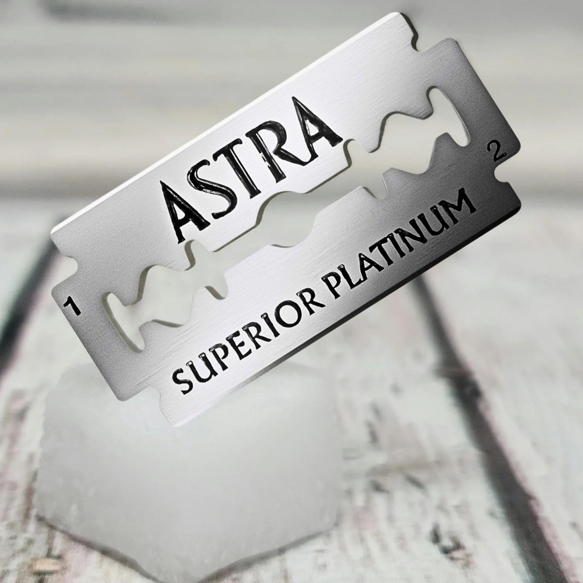 Platinum-coated stainless steel blade detail conveys premium durability and smooth gliding.