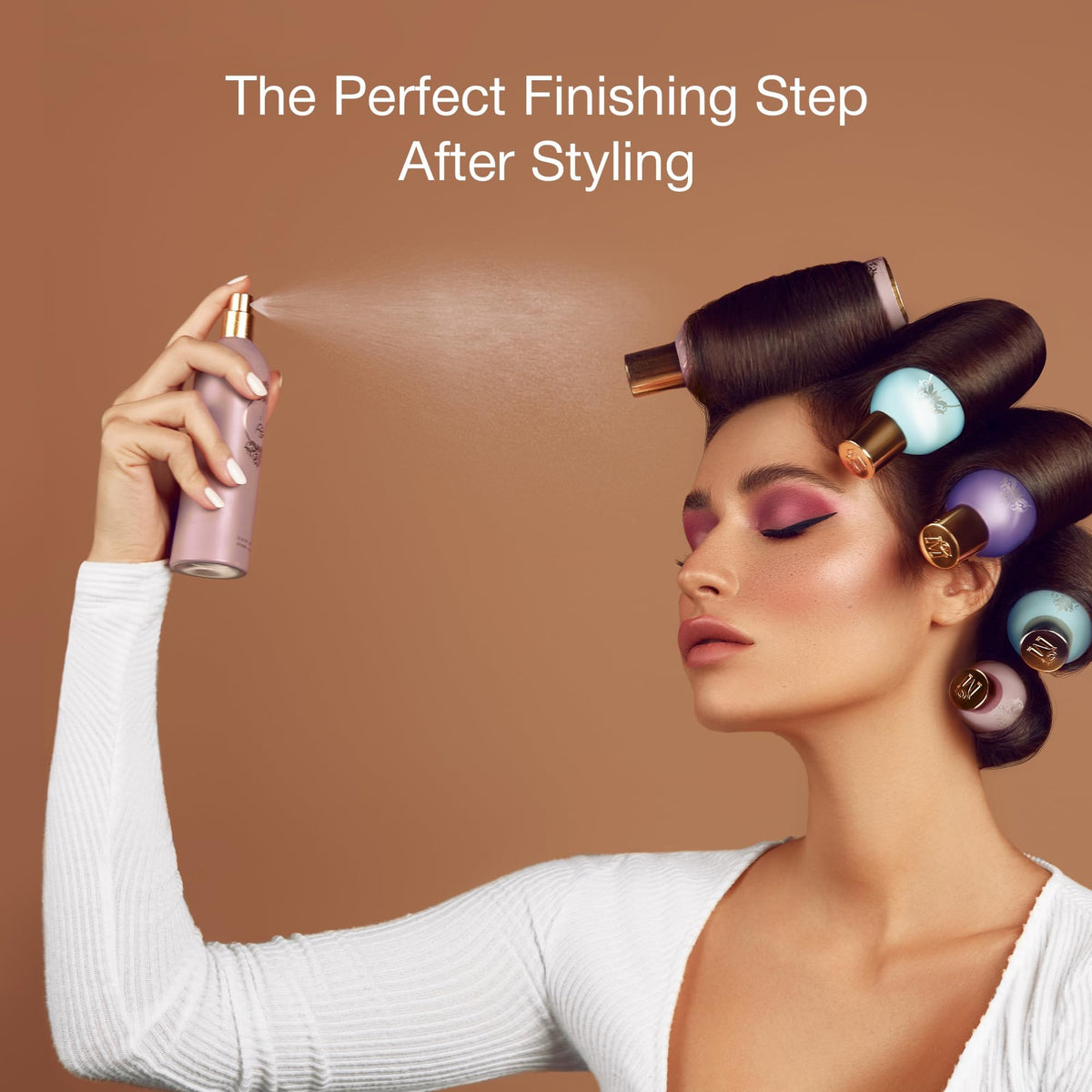 ATYAB AL MARSHOUD Pink Khisla Hair Mist on a vanity beside a comb.
