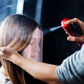 Pink shield designed for hair stylists in salon environments