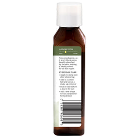 Aura Cacia Balancing Jojoba Oil applied to the face for quick absorption