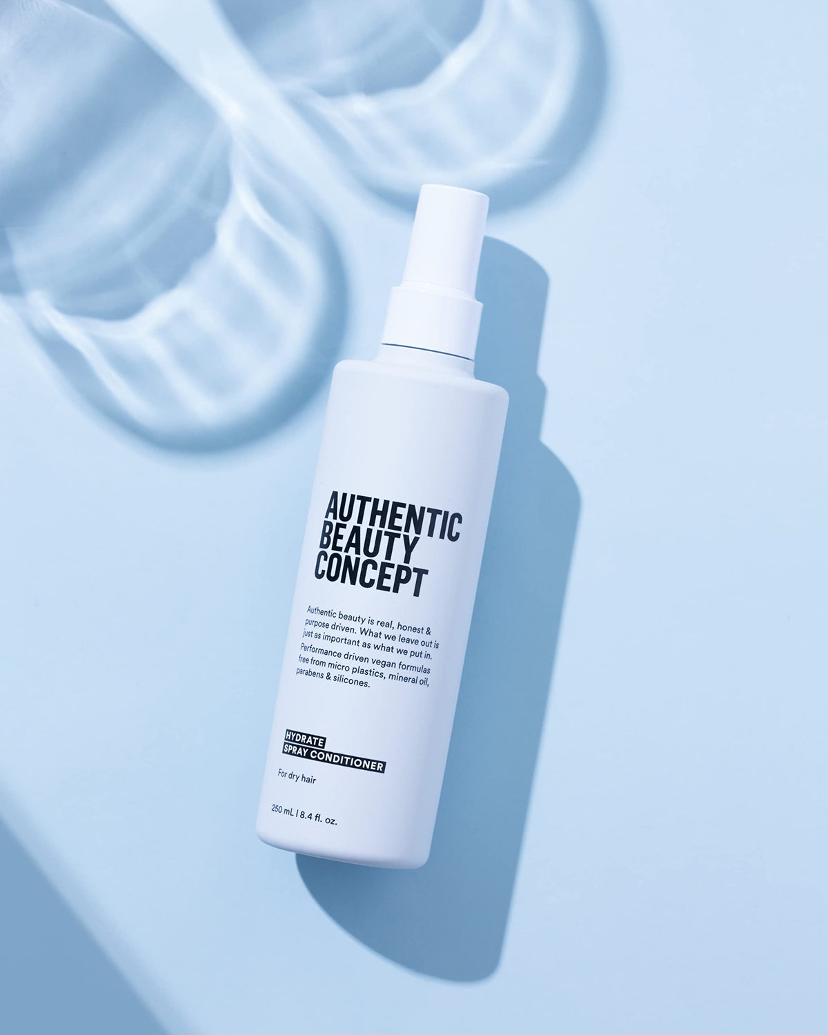 Authentic Beauty Concept Hydrate Spray Conditioner texture close-up showing lightweight formula.
