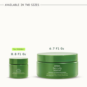 Aveda Be Curly hands applying masque on damp hair.