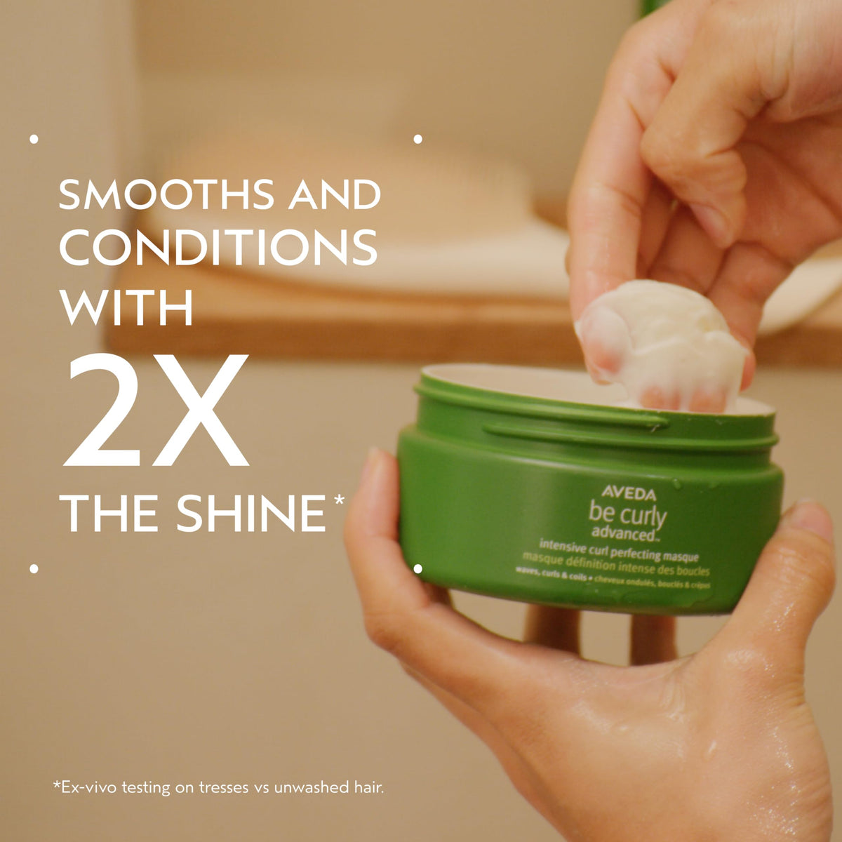 Aveda Be Curly jar close-up highlighting silicone-free deep conditioning.
