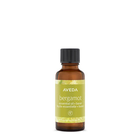 Aveda Bergamot Essential Oil + Base bottle pour showing refreshing citrus aroma for body and bath.