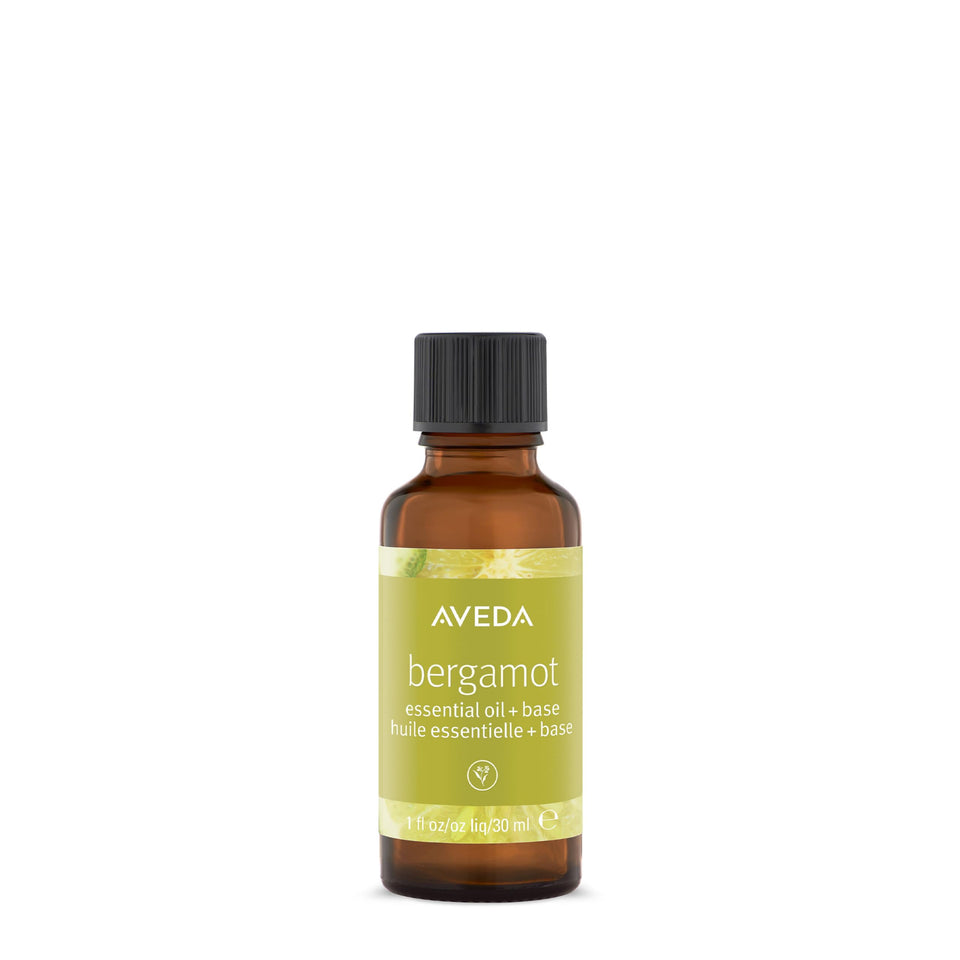 Aveda Bergamot Essential Oil + Base bottle pour showing refreshing citrus aroma for body and bath.