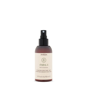 Aveda Chakra 4 Heart Balance bottle close-up for calming rituals.