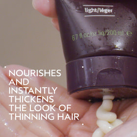 Close-up of Aveda Invati Ultra Advanced Thickening Conditioner Light label and benefits