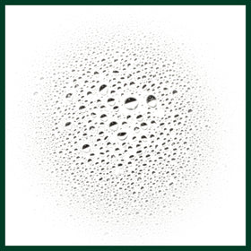 Aveda protective mist near pollution backdrop illustrating environmental shield benefits.