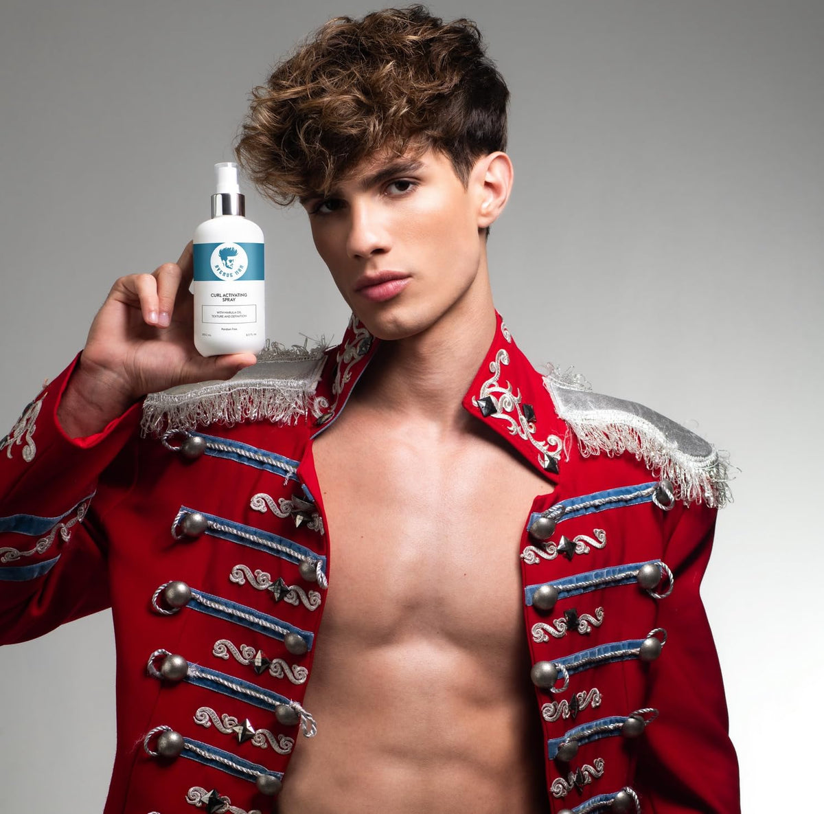 Hands applying Avenue Man Curl Activating Spray to damp hair for definition