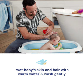 Newborn bath scene with Baby Dove for delicate skin comfort.