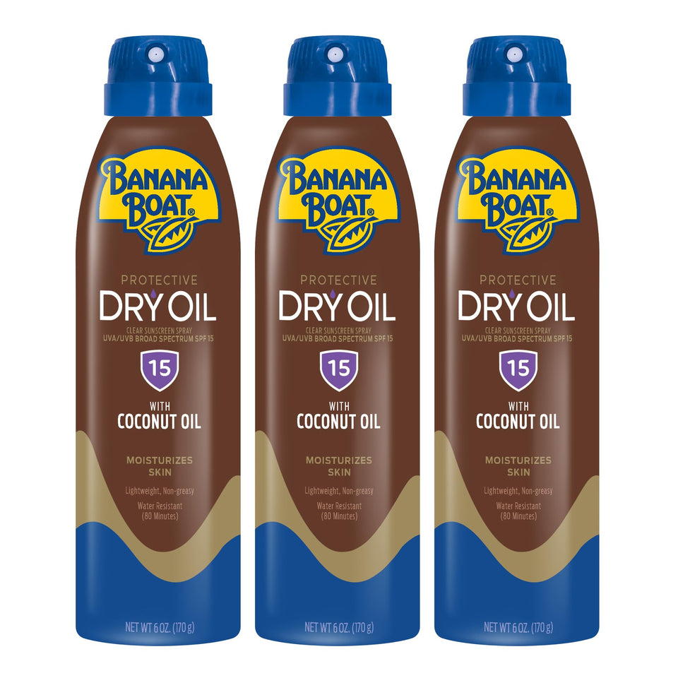 Banana Boat protective tanning dry oil clear spray in hand for quick, even application