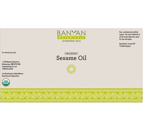 Banyan Botanicals abhyanga massage oil hands applying sesame oil for grounding routine.