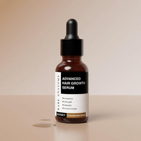 Bare Anatomy serum dropper applying precision drop to scalp.