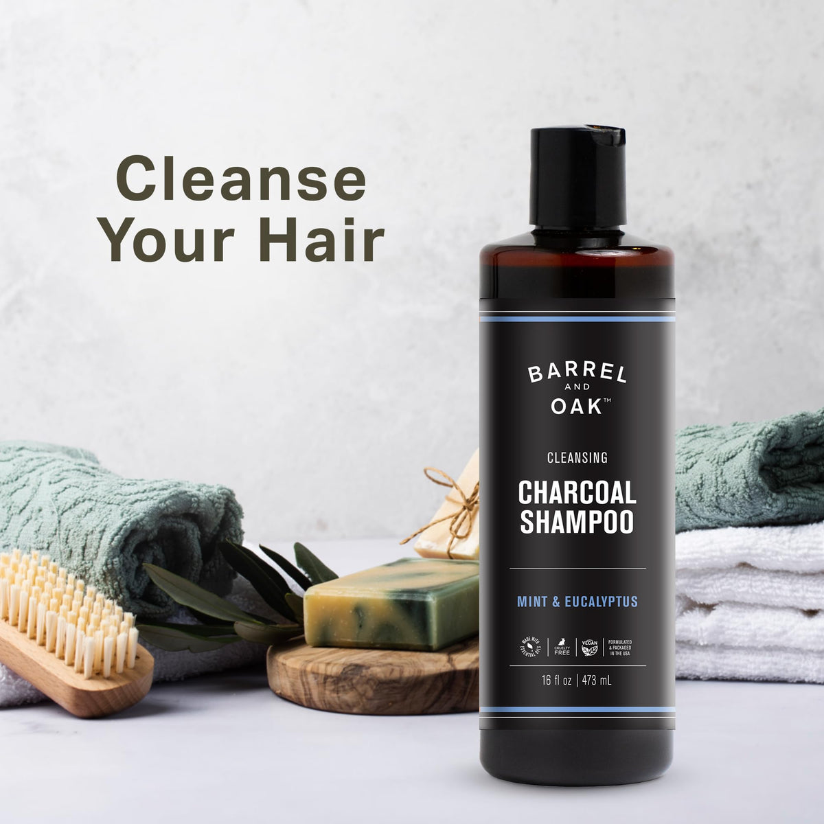 Barrel and Oak mint eucalyptus charcoal shampoo bottle with leaves offers refreshing botanical aroma.