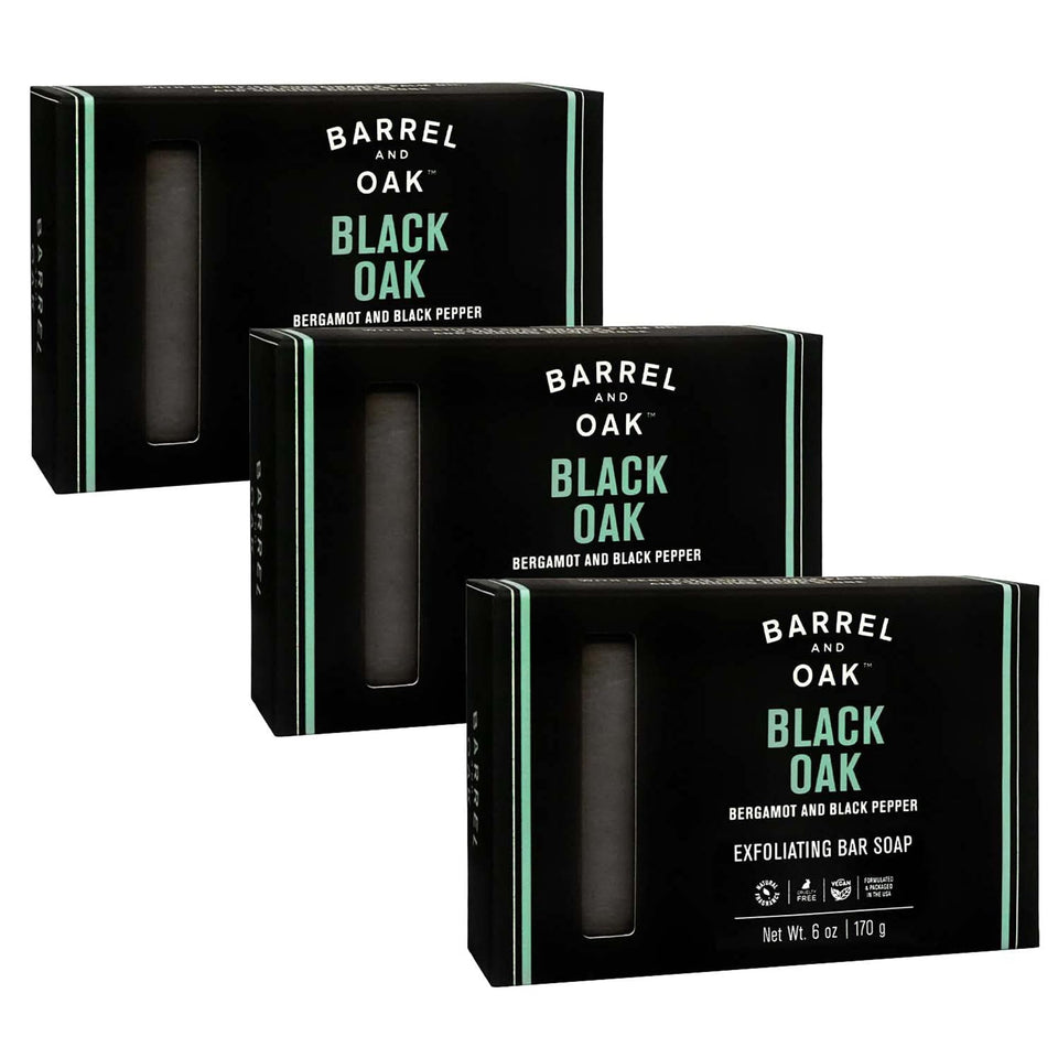 Barrel & Oak Black Oak exfoliating bar soap in hand for rugged cleansing.