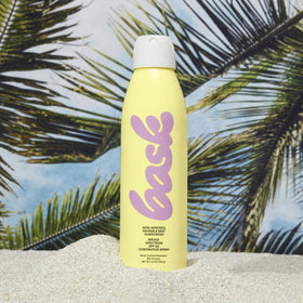 Bask SPF 50 spray featuring 360° nozzle for upside-down application.