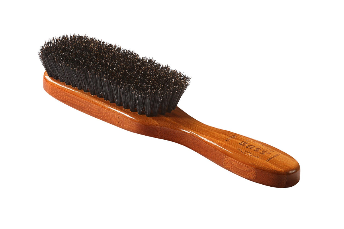 Bass semi oval boar wood brush bamboo handle closeup emphasizes sustainable materials.