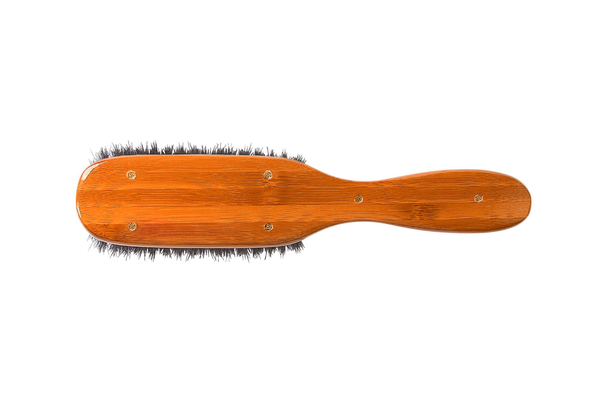 Bass semi oval boar wood brush fine hair closeup suggests gentle grooming.