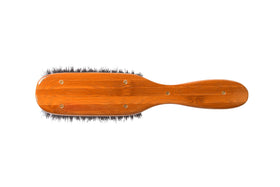Bass semi oval boar wood brush fine hair closeup suggests gentle grooming.