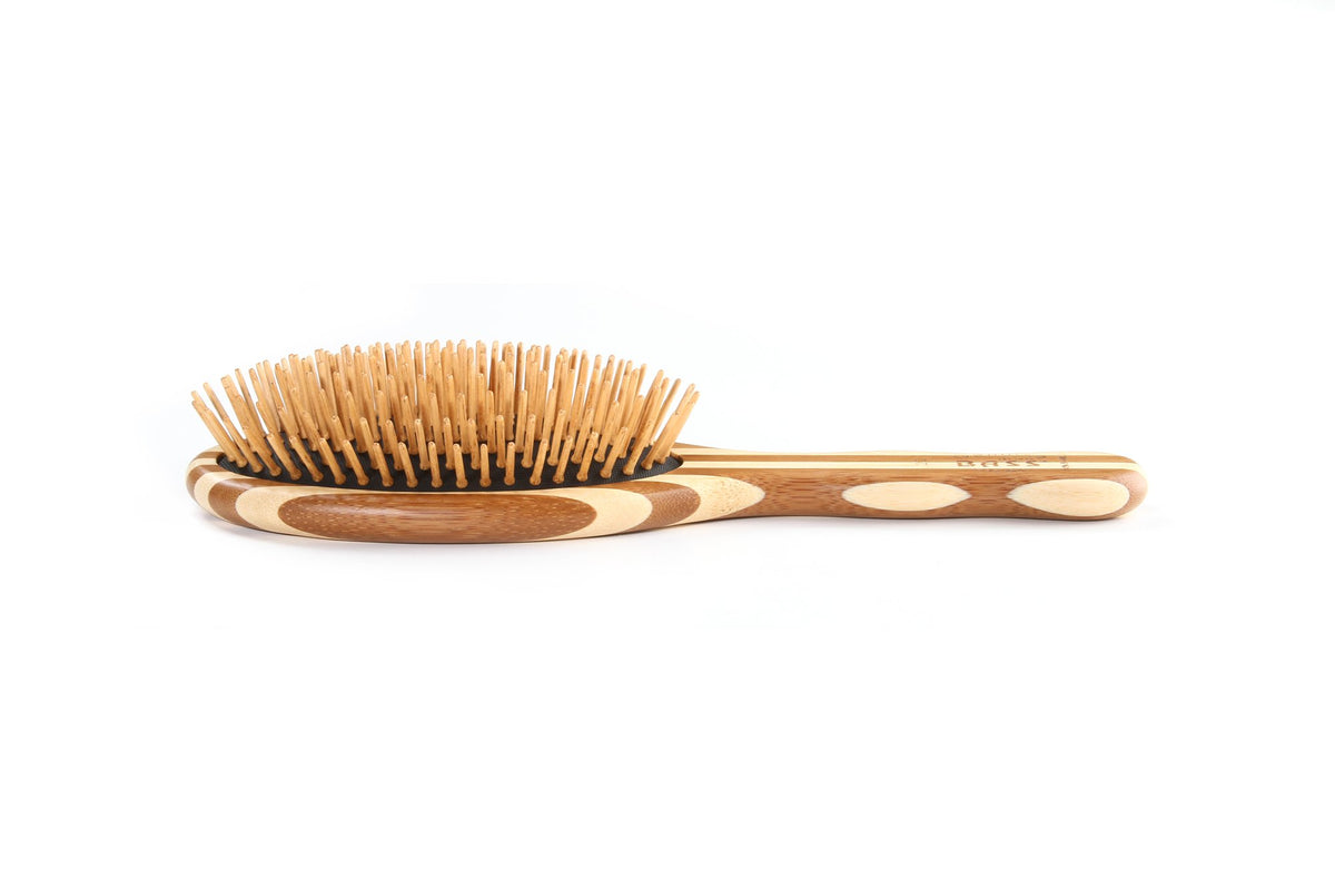 Bass The Green Brush bamboo handle close-up shows sustainable craftsmanship and comfortable grip.