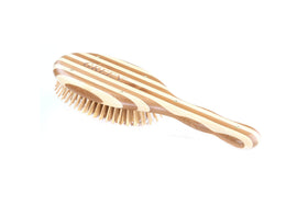 Bass The Green Brush vegan approved logo close-up for cruelty-free hair care.