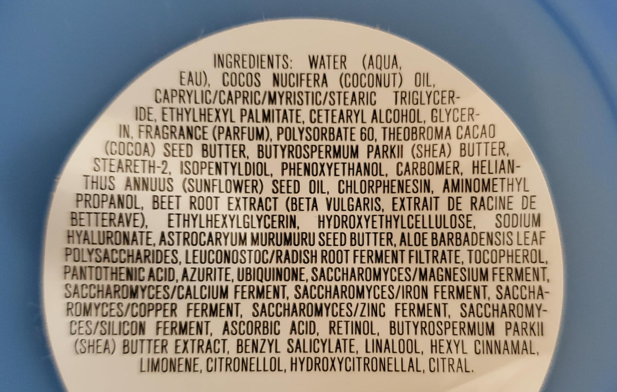 Applying Bath & Body Works body butter to hands for daily comfort.
