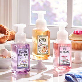 Family hands washing with Rose Water and Ivy soap in a bright bathroom.