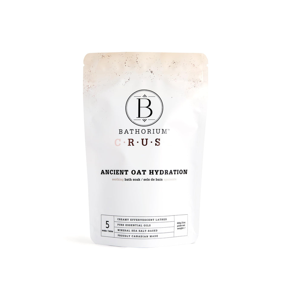 Bathorium Ancient Oat Hydration Crush bottle pour shows hydrating, creamy bath water.