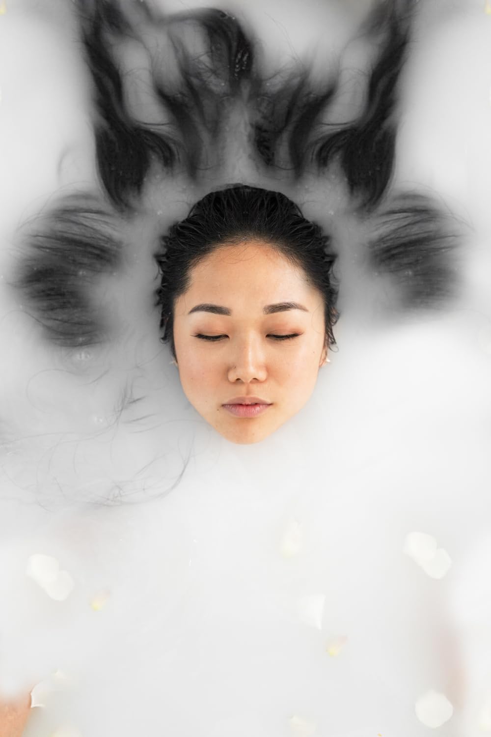 Bathorium Milk Mineral Bath Soak in tub with soft foam invites relaxing self-care.