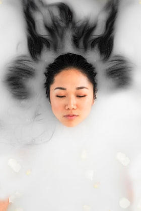 Bathorium Milk Mineral Bath Soak in tub with soft foam invites relaxing self-care.